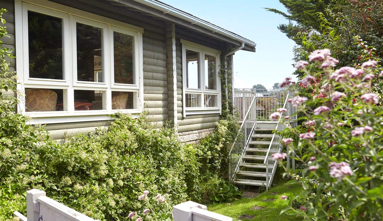 Welcome to House of Logs, a truly unique property just a short walk from Totland Bay. Steps lead up to the balcony from the garden.