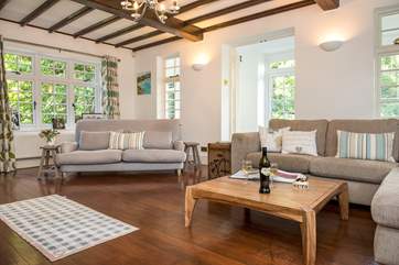 The sitting-room is a delightful triple-aspect room.