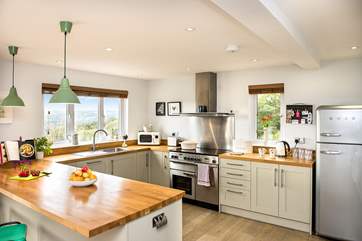 The stylish kitchen has a large range cooker and a trendy Smeg fridge/freezer.