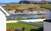 The balcony overlooks the decking area and shared lawn and from the side of the balcony you can see Porth beach.  - Thumbnail Image