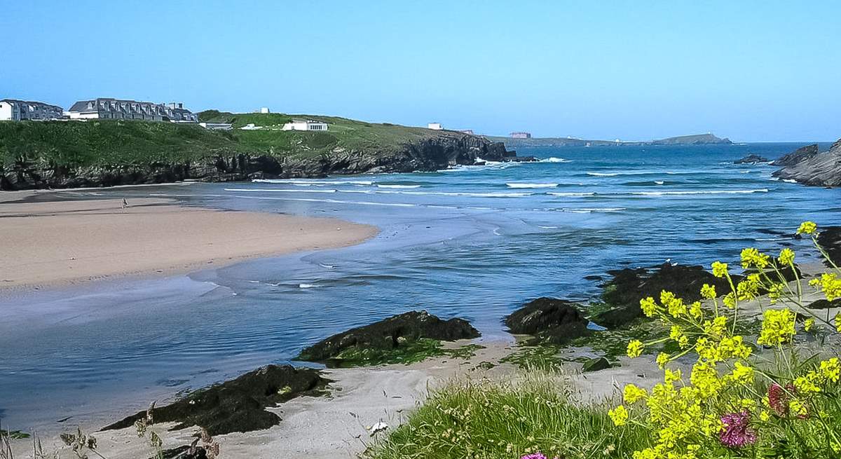 Glendorgal (seen top left) sits on its own private 17 acre headland beside Porth Beach.