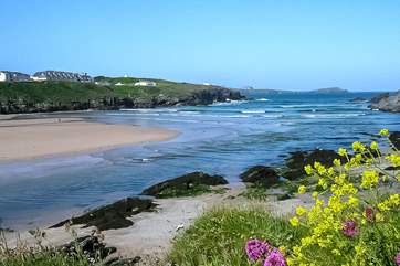 Glendorgal (seen top left) sits on its own private 17 acre headland beside Porth Beach.