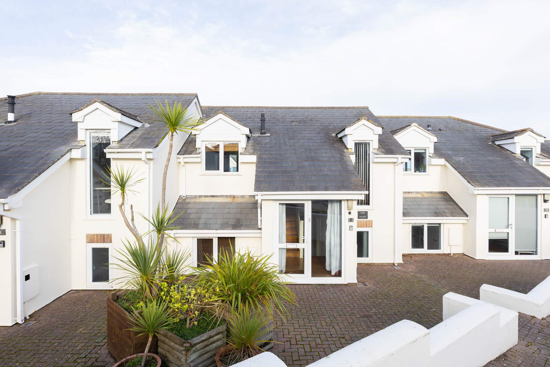 Puffin is a two-storey house, in a small horseshoe of 15 properties, nestled above the beach. You can access the property either via a ramp or flight of steps. The parking bay is a short walk away from the property. 
