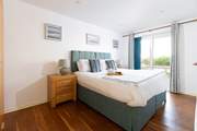 This large bedroom is decorated in calming blues. It over looks the decking with French doors that open directly to it, perfect for those summer mornings (Bedroom 2).