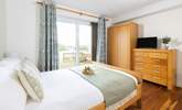 This main bedroom has a double bed and en-suite shower room and a glimpse of the headland (Bedroom 1).  - Thumbnail Image