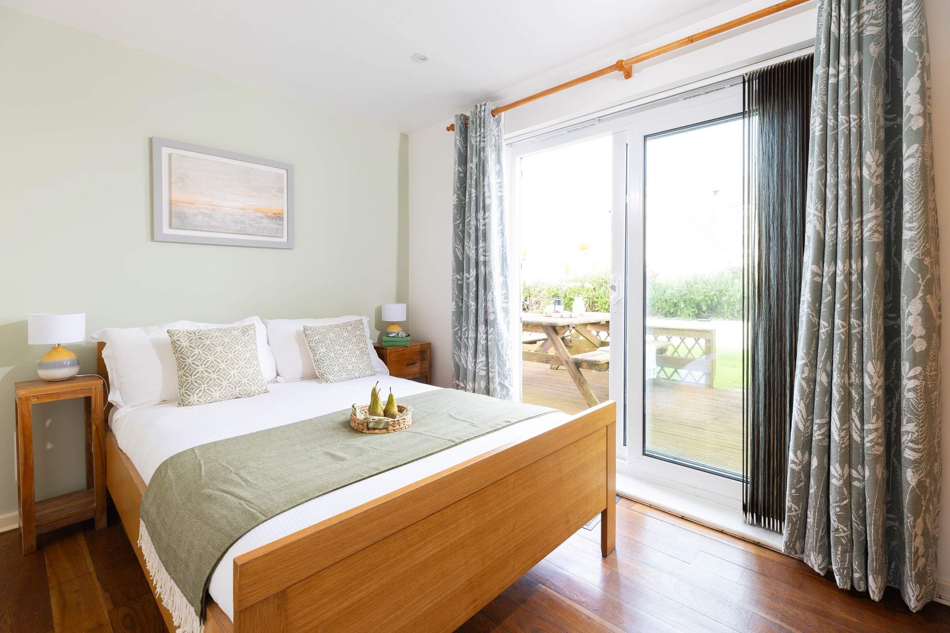This lovely bedroom has French doors out to your decking. 