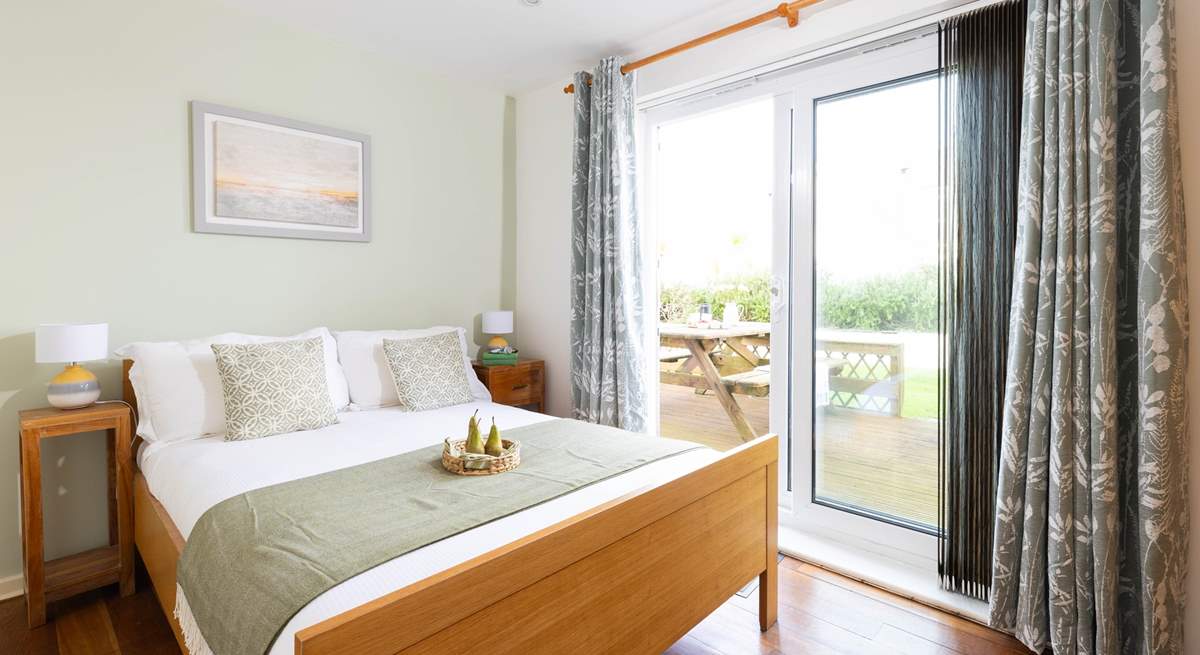 This lovely bedroom has French windows out to your decking. 