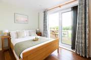 This lovely bedroom has French doors out to your decking.