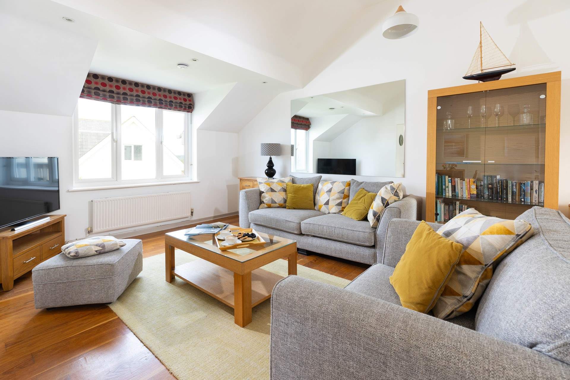 The open plan living space is light and airy, a great spot to relax together. 