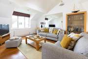 The open plan living space is light and airy, a great spot to relax together.