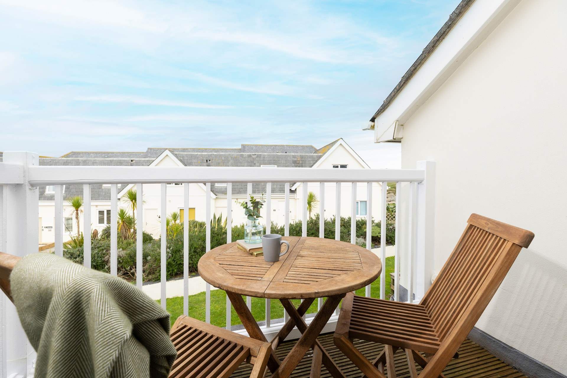 Double doors open to the balcony where you can just about see the sea from the side. What a lovely spot for your morning coffee.