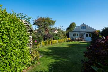 The large enclosed back garden enjoys the sun all day.