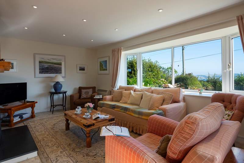 The sitting-room has views of the sea from the large bay window.
