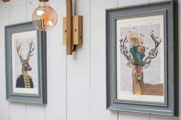 Quirky prints hang on the wall.