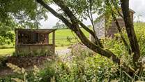There's a rustic outdoor kitchen behind the hut. 