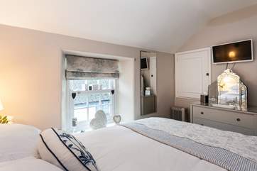 There are calming tones in the master bedroom.