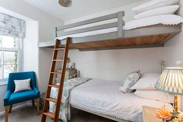 The bunk bedroom is light and bright.