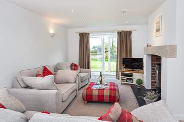 The sitting-room has patio doors which open up onto the rear garden.