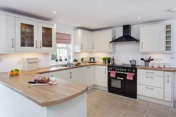 The kitchen boasts a range cooker and also overlooks the garden.