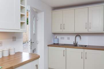 The useful utility-area, incorporated in the kitchen/diner. The back door leads out onto the driveway.