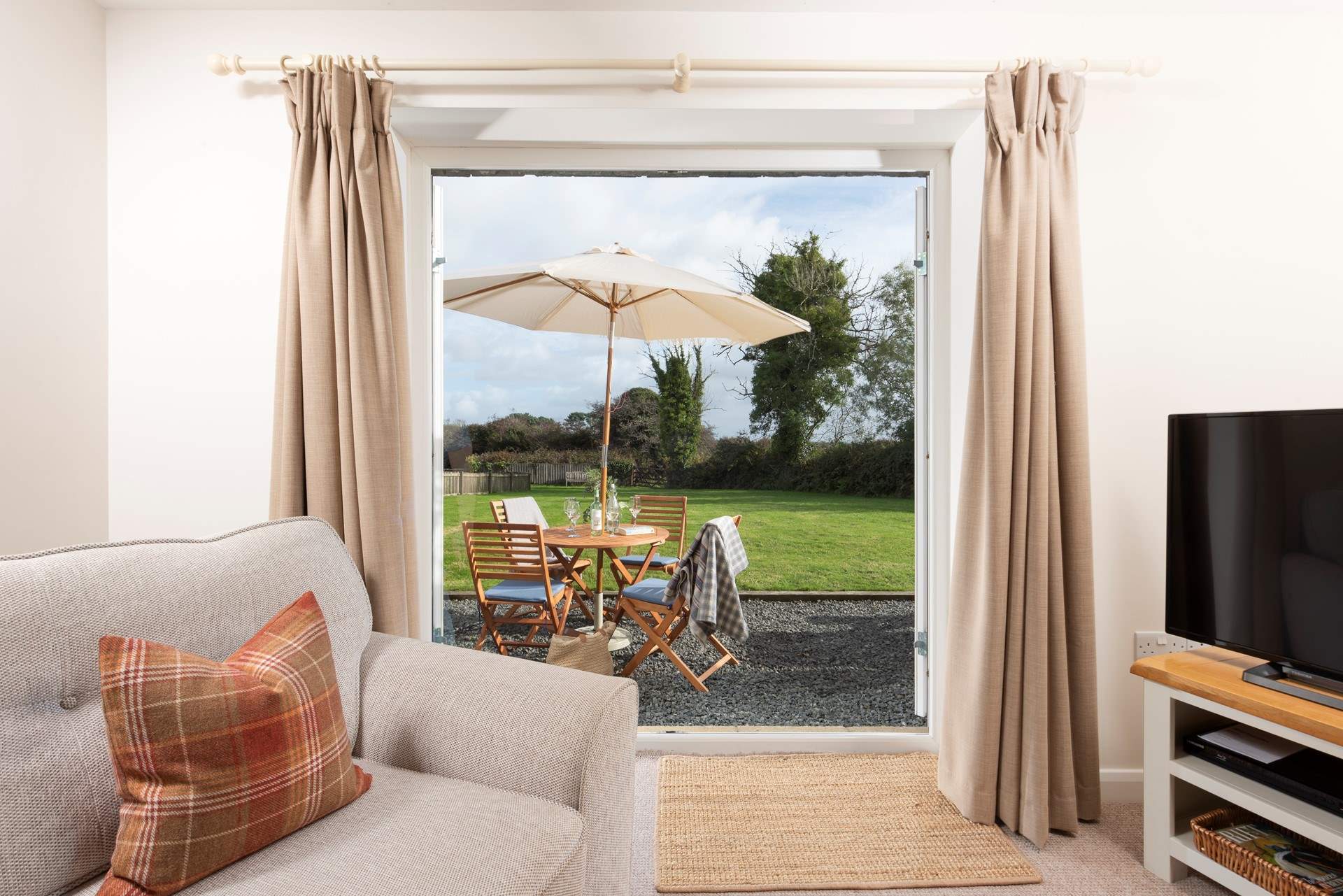 The sitting-room features French doors that open up to the garden.