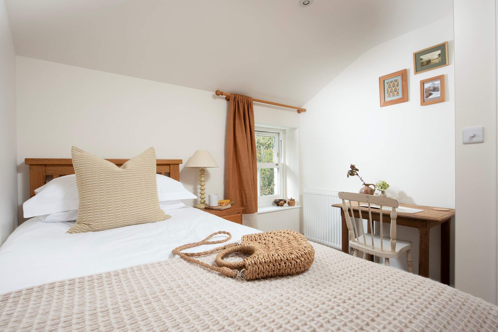 Bedroom 4 features a sash window and a handy writing table.
