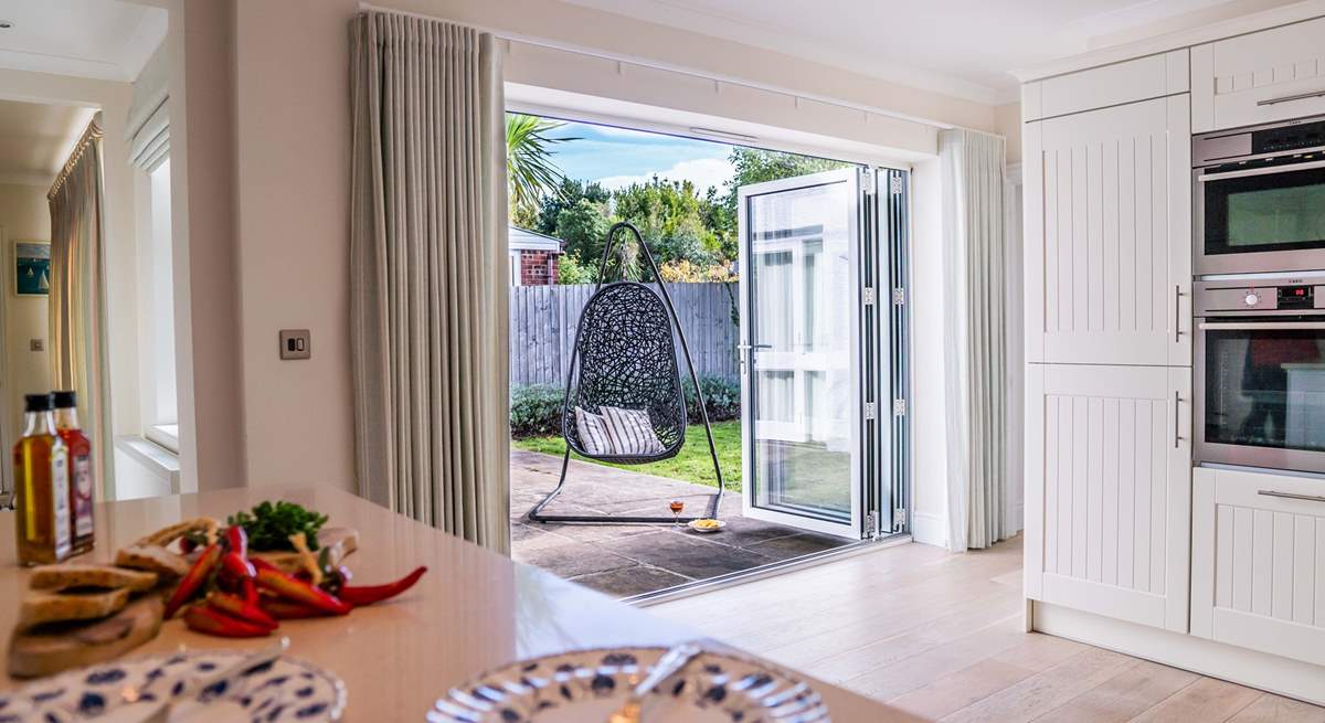 There are bi-fold doors from the kitchen leading to the patio and garden area.