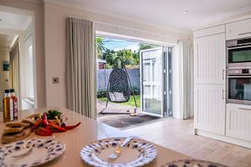 There are bi-fold doors from the kitchen leading to the patio and garden area.