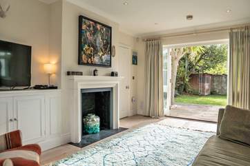 The sitting-room has doors that open up to the enclosed garden.
