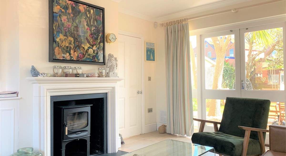 The sitting-room has a cosy wood-burner. There are doors that open up to the enclosed garden.