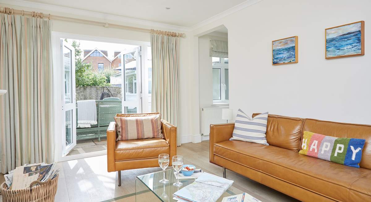 The cosy sitting-room has patio doors that open up to the enclosed garden.