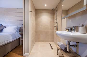 There is a huge walk-in shower, as well as wash-basin and WC.