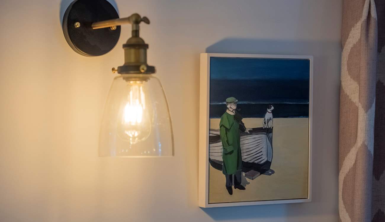 A delightful oil painting, by local artist Lizzie Bridges, above the dining-area.