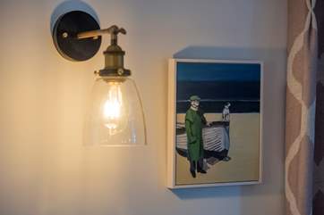 A delightful oil painting, by local artist Lizzie Bridges, above the dining-area.