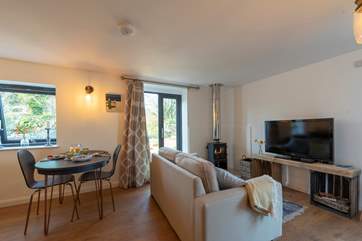The open plan living-room is inviting and cosy, with plenty of room to spread out and relax.