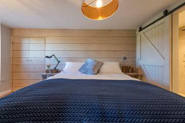 To the left of the bed, there is a handy wardrobe with plenty of hanging space (there's a chest of drawers too), so you won't be short on storage.