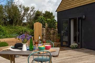 French doors lead from the living-room out to the decking - dining al fresco is a must.