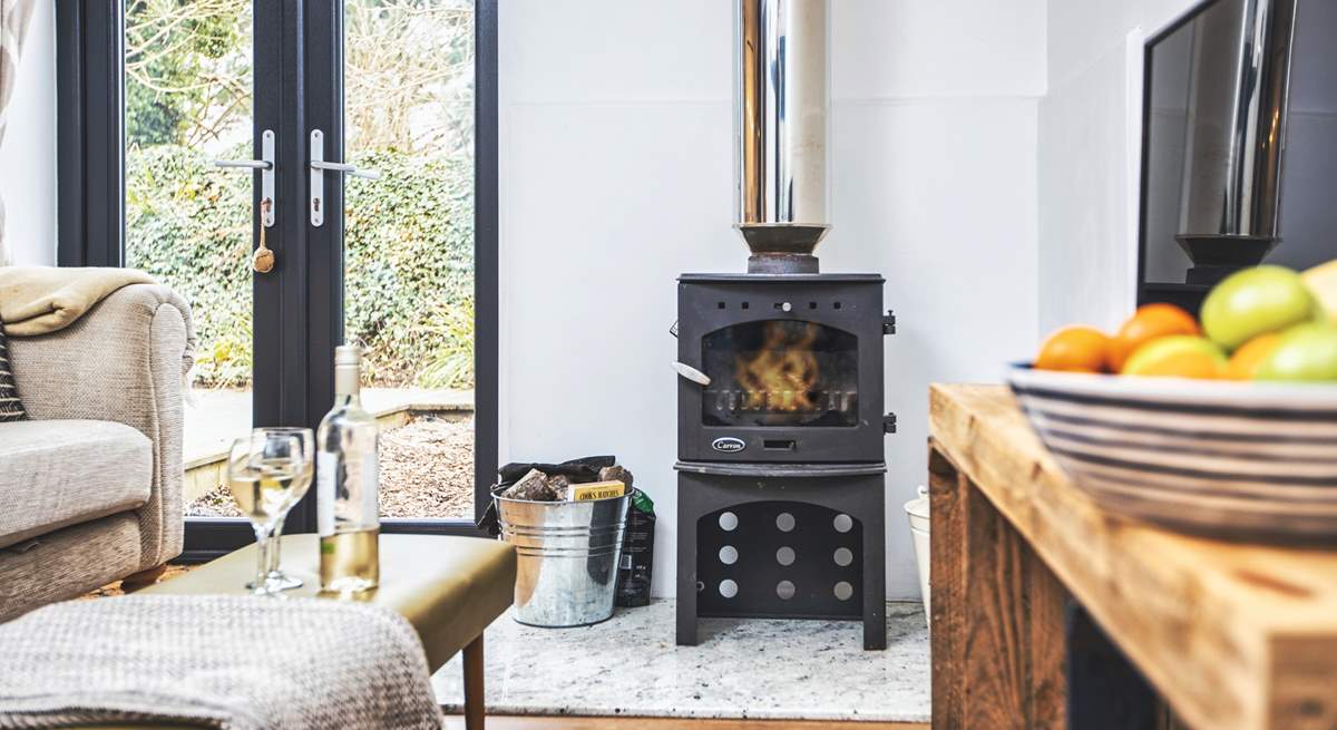 Get cosy on the sofa in front of the wood-burner. 