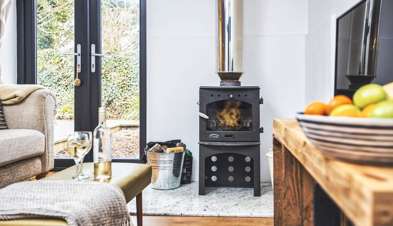 Get cosy on the sofa in front of the wood-burner. 