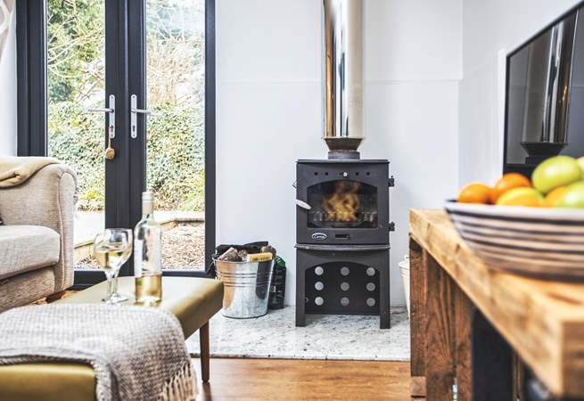 Get cosy on the sofa in front of the wood-burner. 