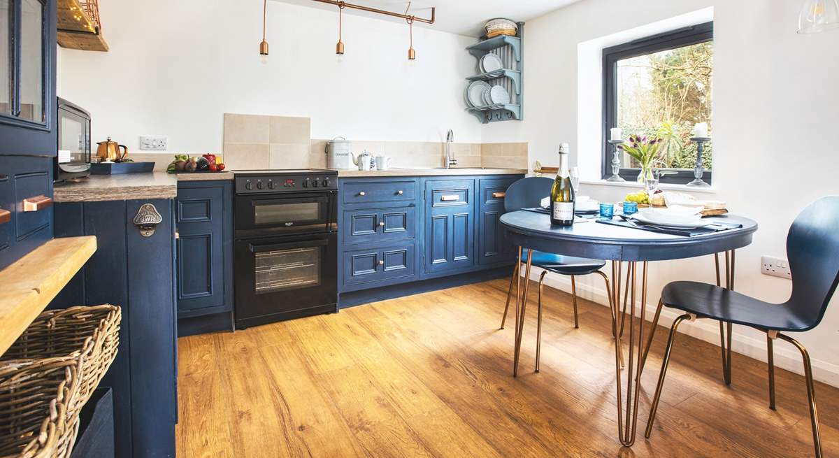 This cute kitchen overlooks your private patio bordered by pretty flowers and shrubs. 