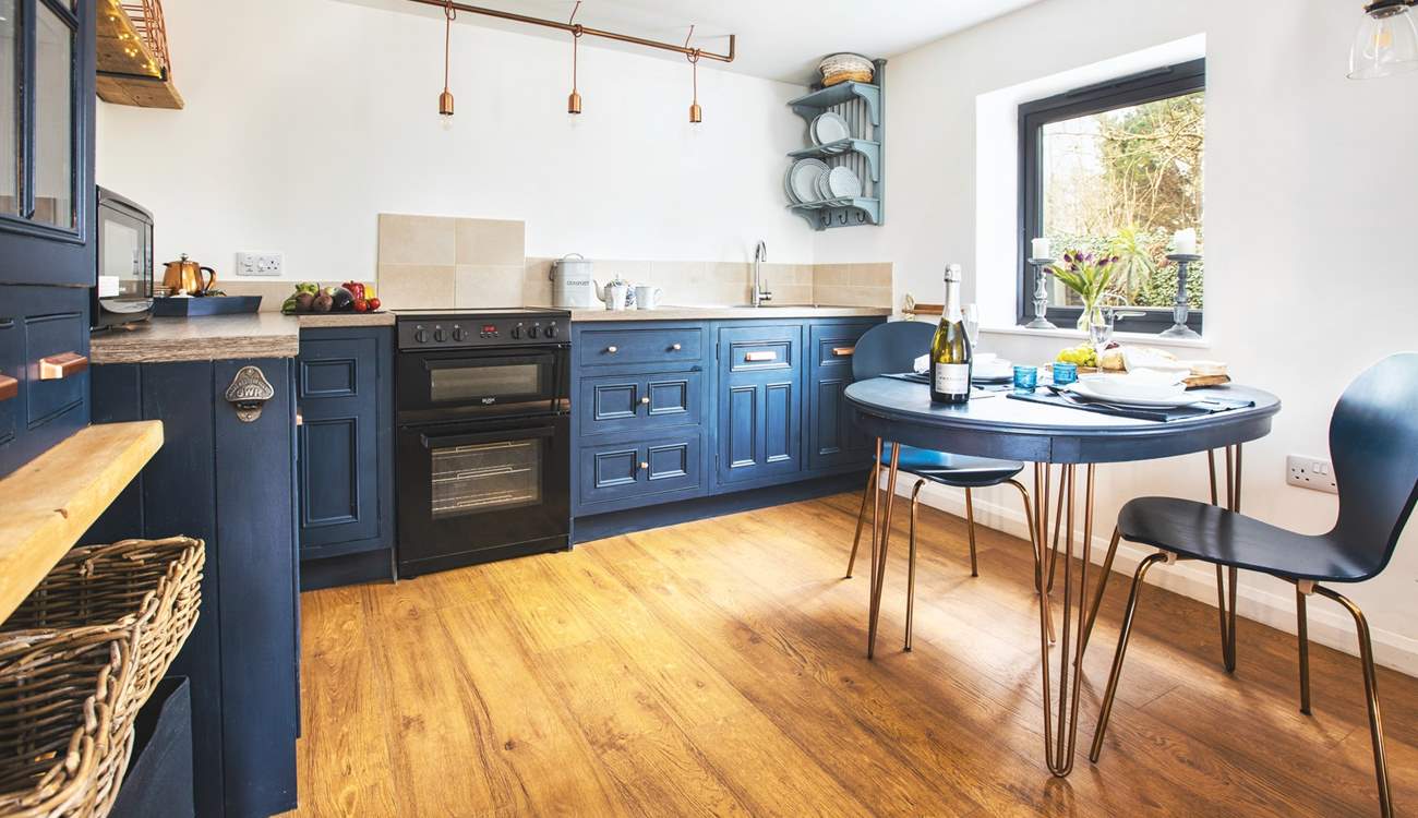 This cute kitchen overlooks your private patio bordered by pretty flowers and shrubs. 
