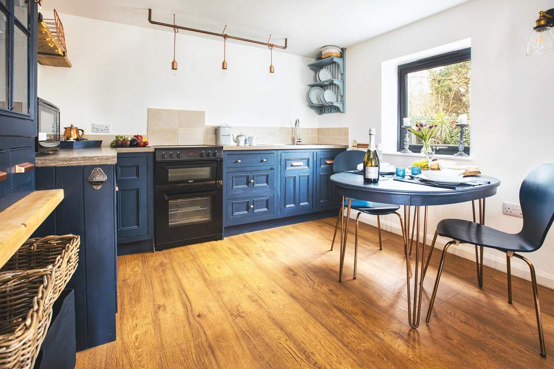 This cute kitchen overlooks your private patio bordered by pretty flowers and shrubs.
