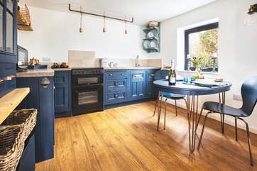 This cute kitchen overlooks your private patio bordered by pretty flowers and shrubs.