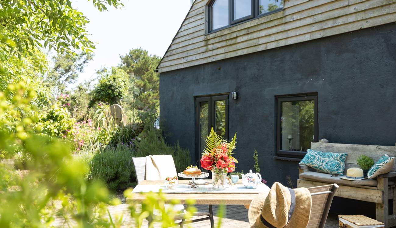 French doors lead from the living-room out to the decking - dining al fresco is a must.