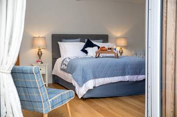 The beautiful bedroom is home to this super-comfy king-size bed.