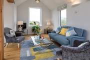 The living area boasts a fabulous view on a summer's day and also offers the perfect place to snuggle up on a winter's day.