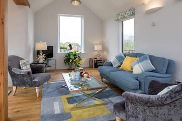 The living area boasts a fabulous view on a summer's day and also offers the perfect place to snuggle up on a winter's day.
