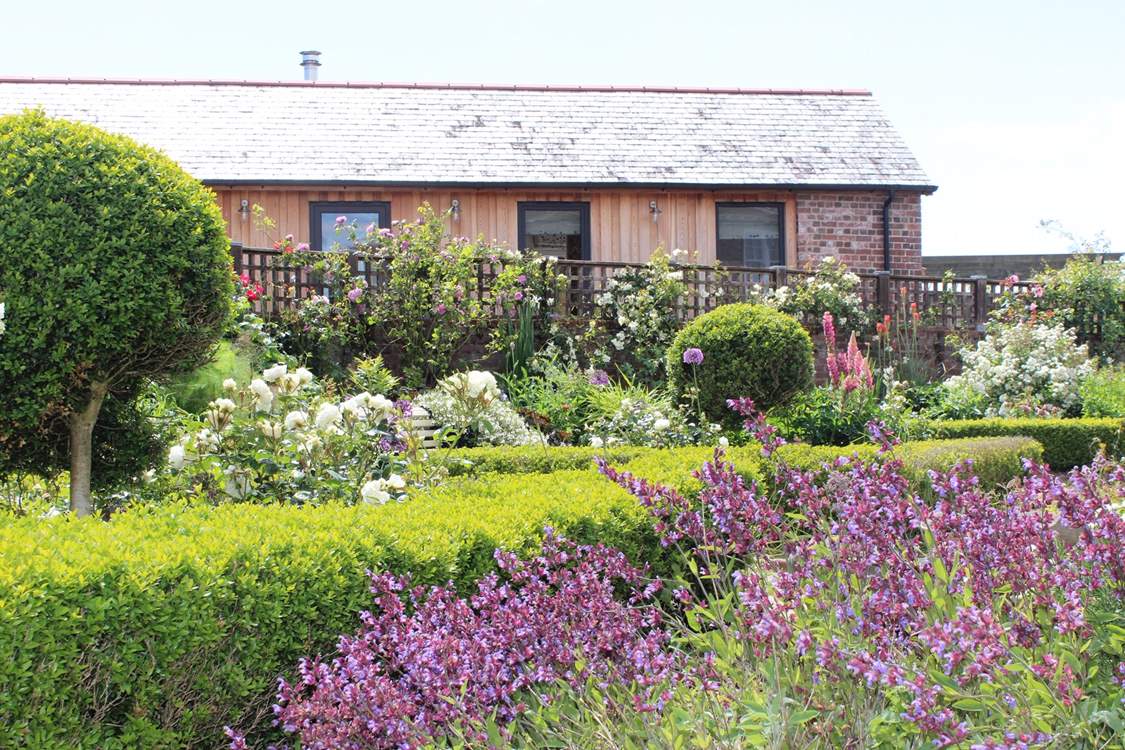 Peeking across at The Old Stables, nestled discreetly behind an array of carefully placed shrubbery.
