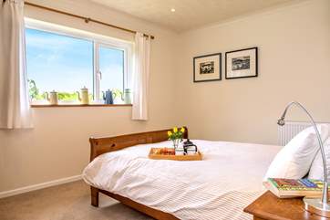 The bedroom at the front of the property has fun teapots and art (Bedroom 1).
